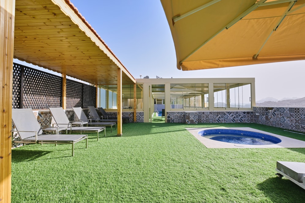 Loungers beside the Petra Breeze Jacuzzi and mountain view