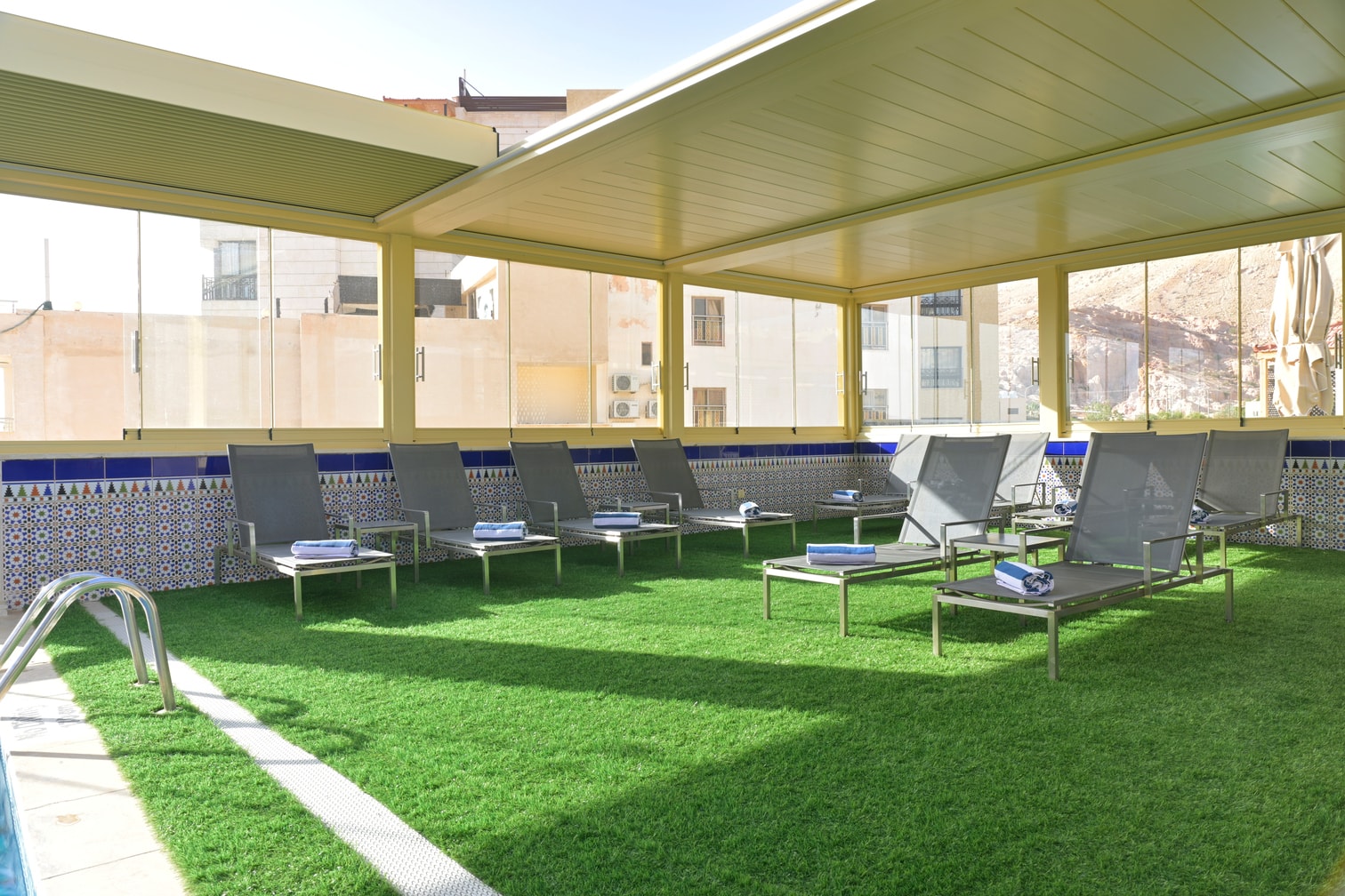 Petra Breeze Pool deck with loungers and fresh towels