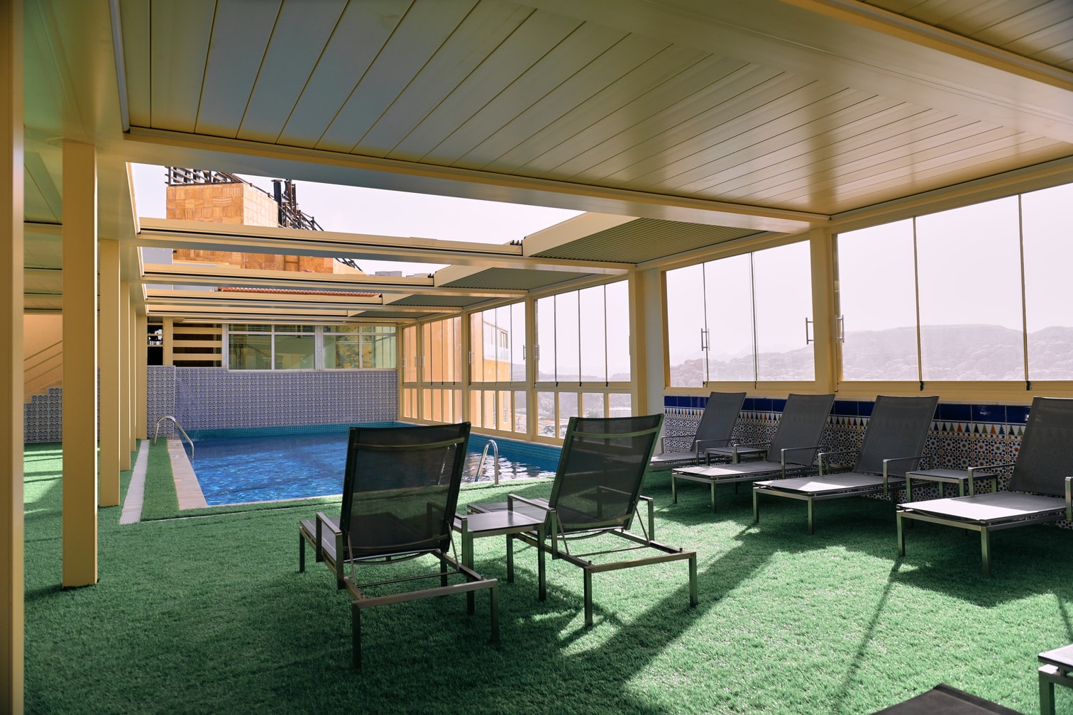 Petra Breeze Pool loungers beside the covered pool