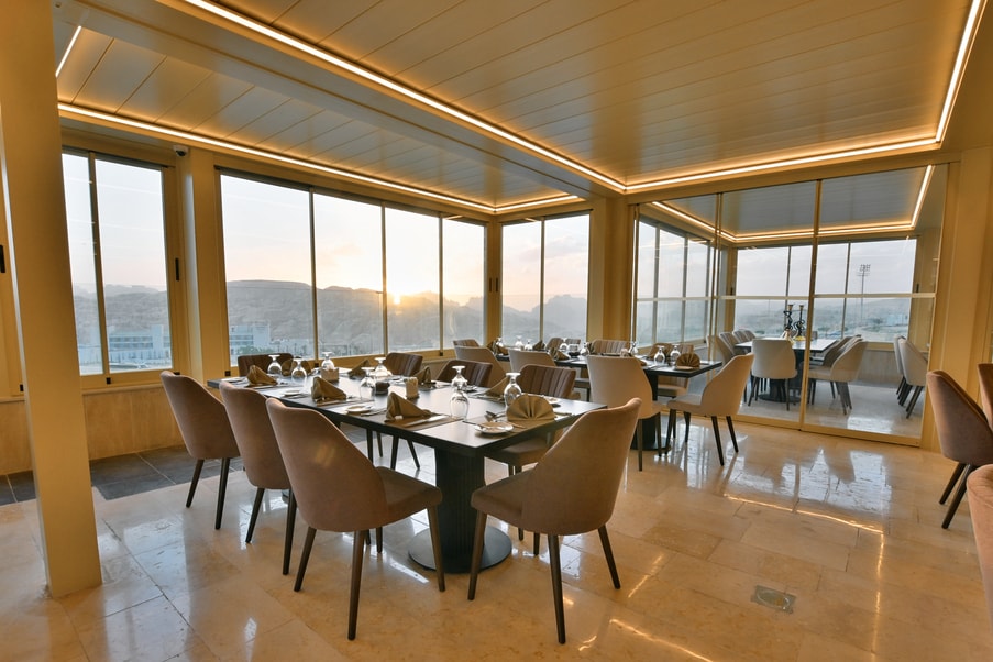 Petra Breeze Restaurant tables set beside sunset views