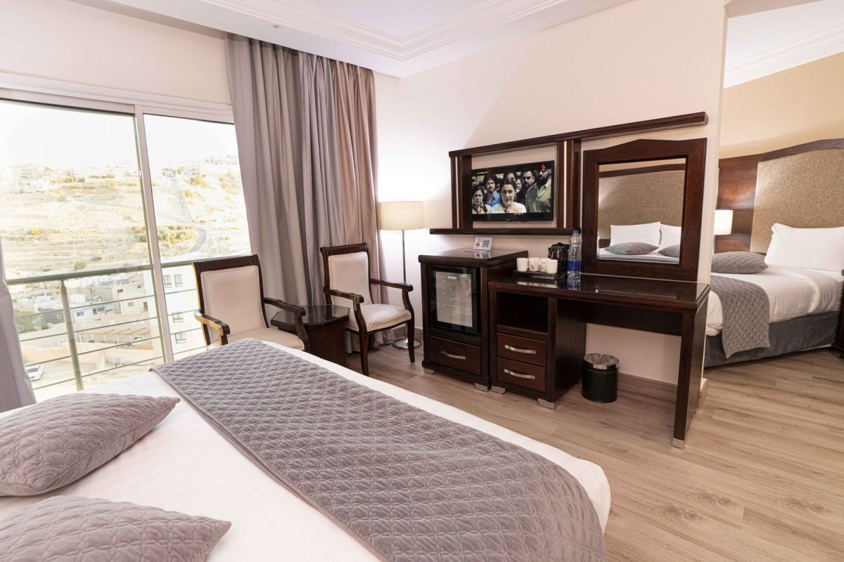 Hotel room with bed, desk and city view