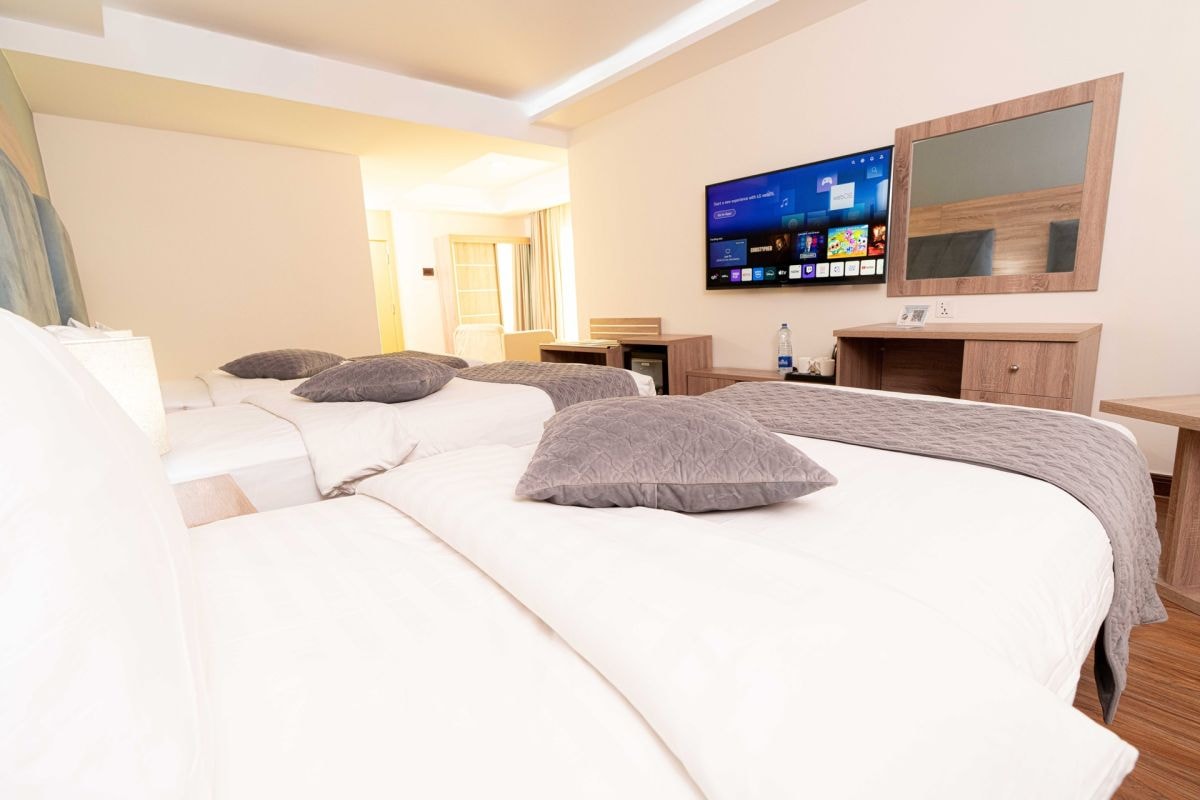 Triple Room with multiple beds and television